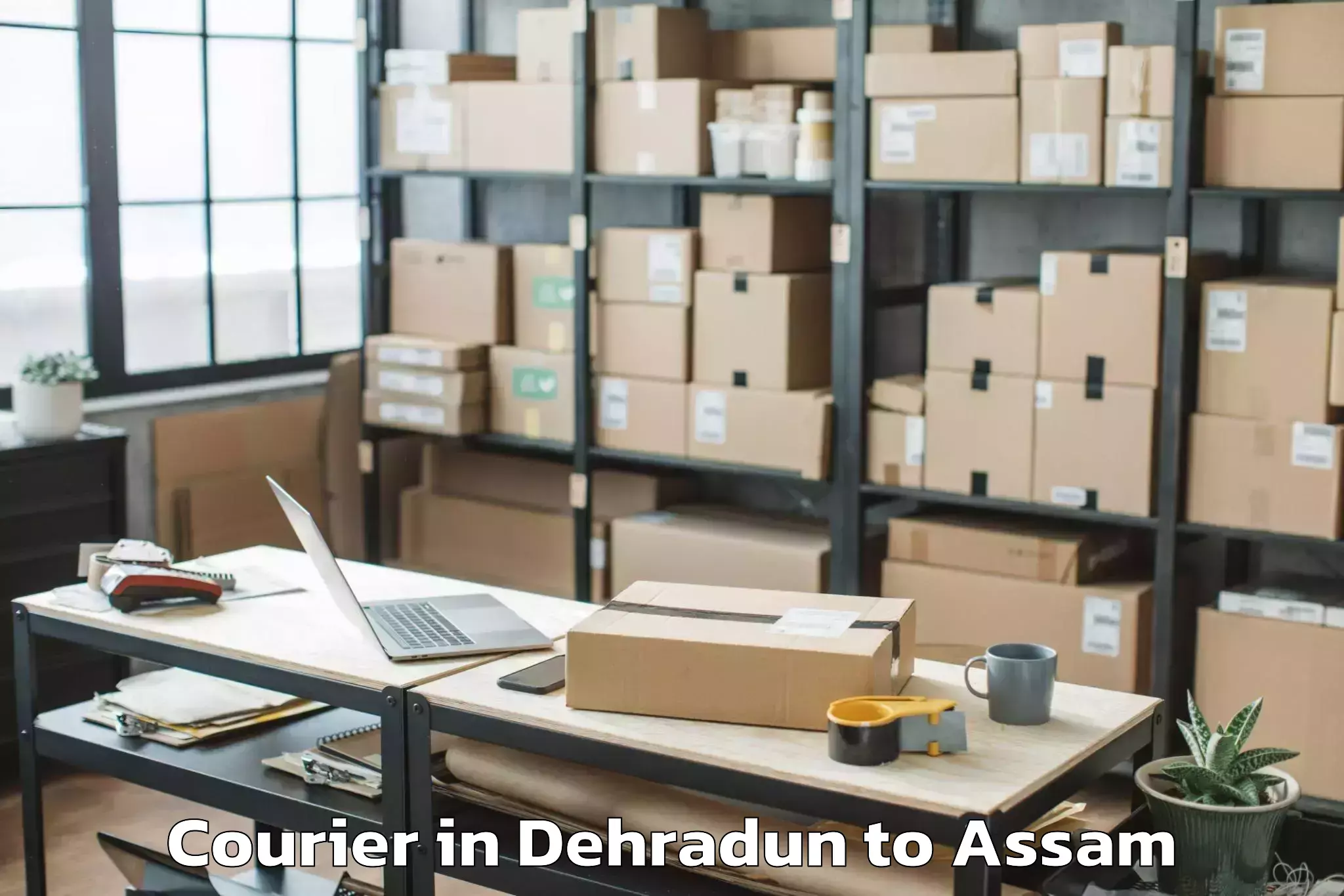 Reliable Dehradun to Kharupetia Courier